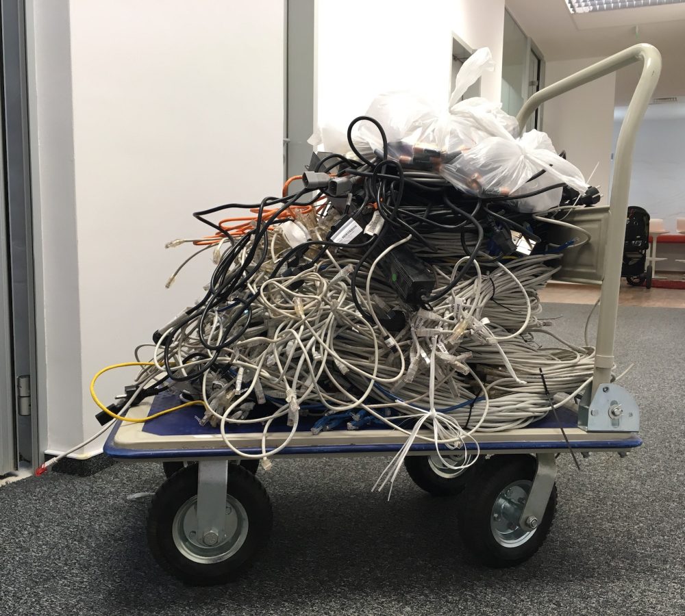 Cart with pile of used internet wires. Recycling electronics